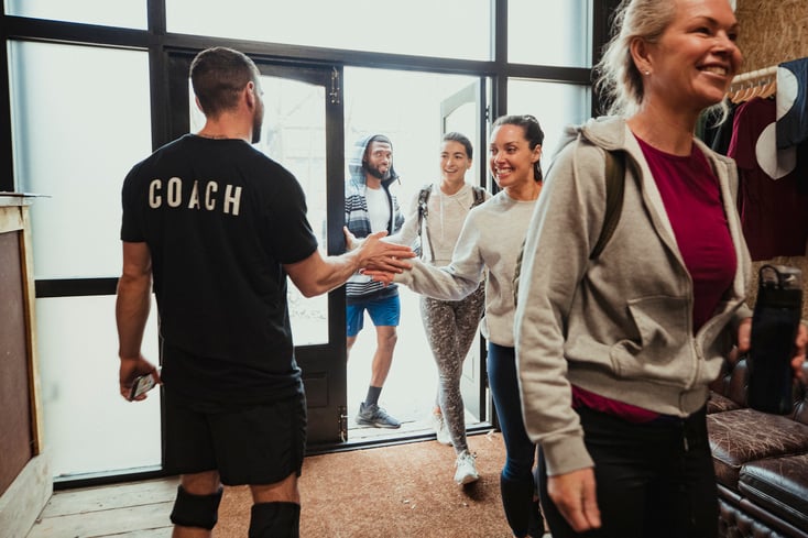 A CrossFit coach welcoming new members to his CrossFit box.