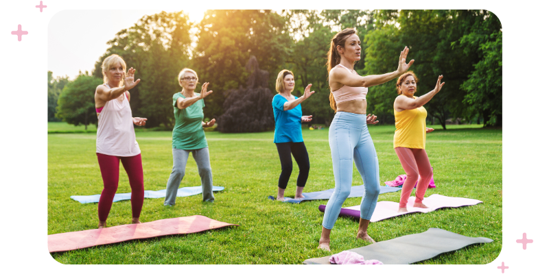 Group of women of different ages exercising in the park