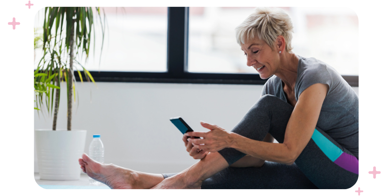 Older woman selecting an on-demand workout from her mobile device