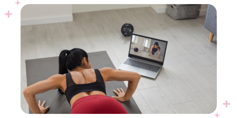 Young woman following a virtual session on her laptop at home