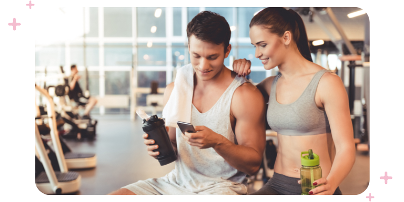 Personal trainer encouraging a tired gym member