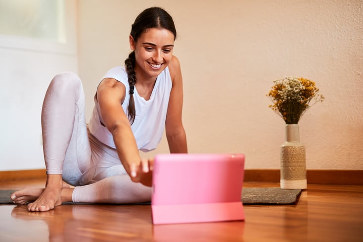 A yoga instructor sets up an online classes in their yoga studio