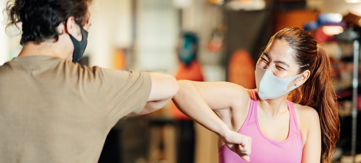 gym owner welcoming back a customer to the gym