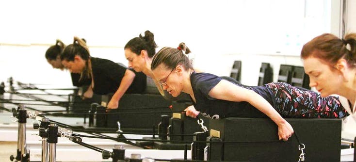 image of amy owner of contour pilates in a class
