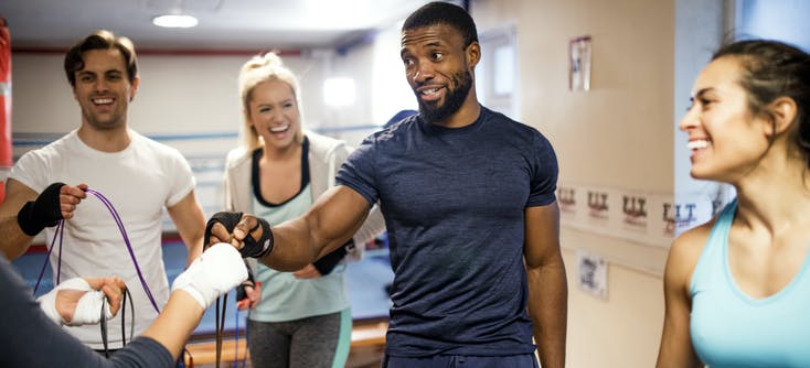 A fitness instructor and his clients enjoy getting back to the gym