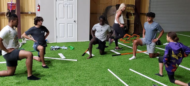 athletes stretching during a small group personal training session