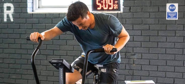 A CrossFit member using a CrossFit bike