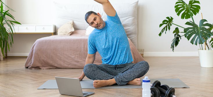 man taking an on-demand class at home