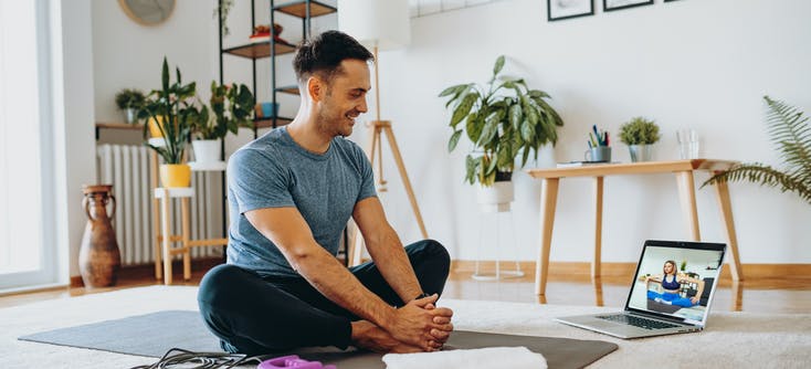 man taking an online fitness class