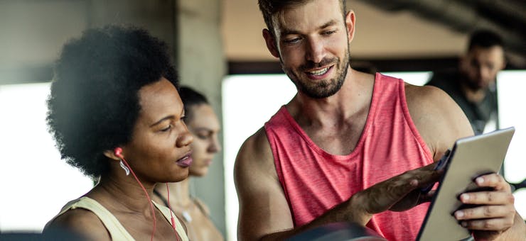 gym instructor filling out personal details with a fitness customer