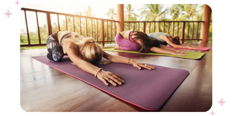 An outdoor yoga class on a deck