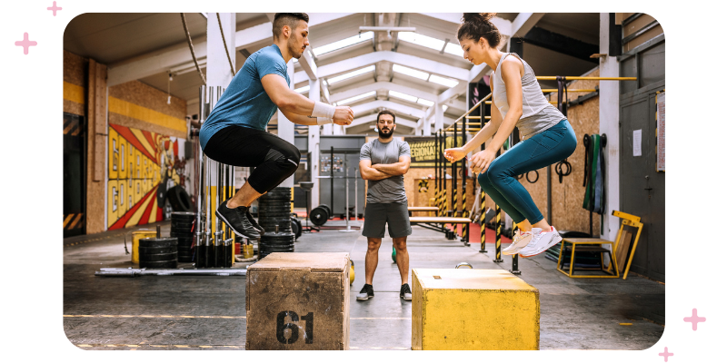 A CrossFit instructor leading a class in their CrossFit gym