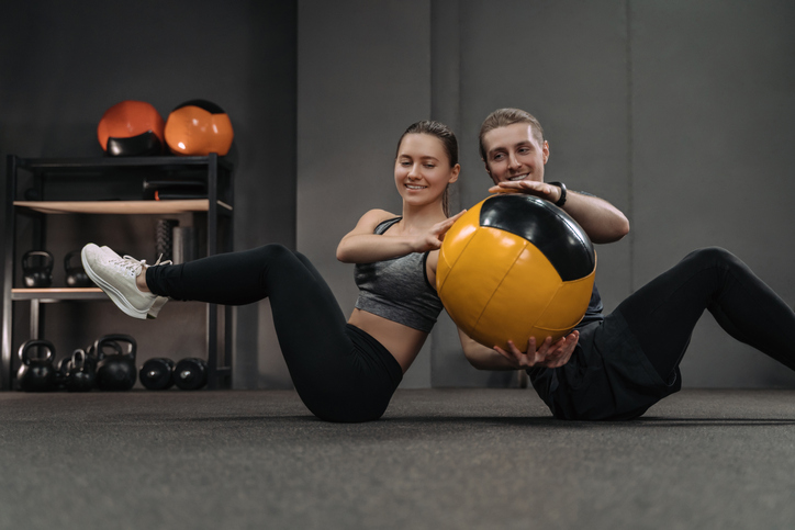 Couple working out with a medicine ball.