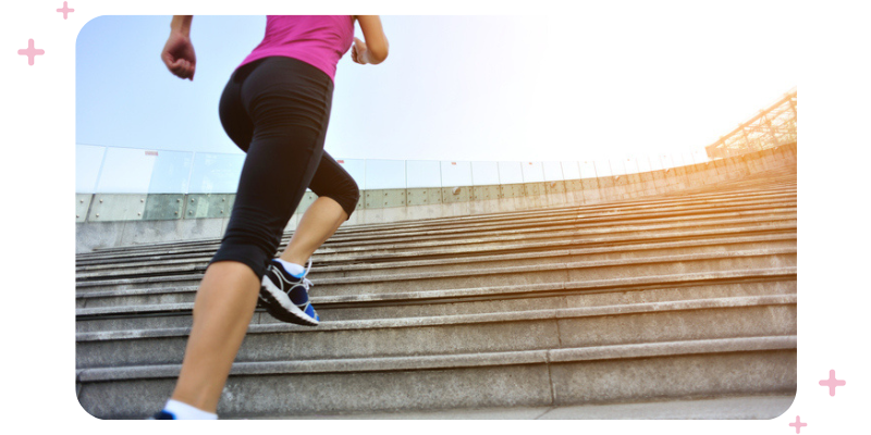 A woman in workout clothes running up steps.