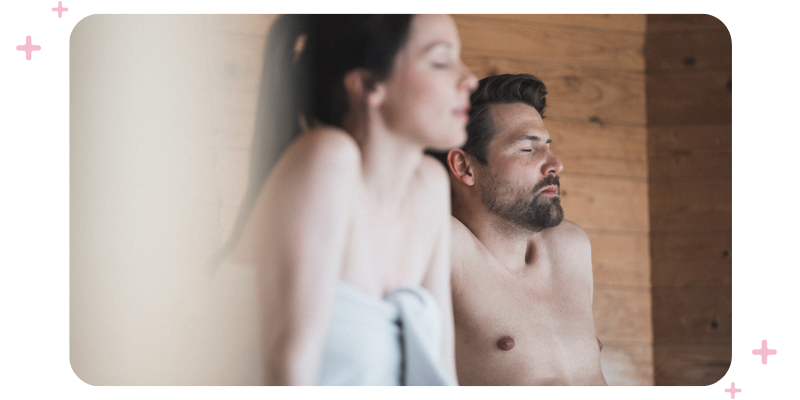 A man and a woman relaxing in a sauna.
