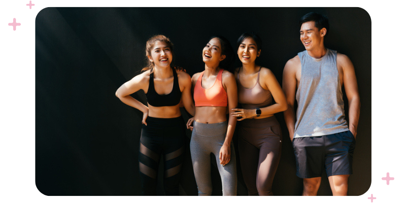 A group of smiling people in workout clothes.