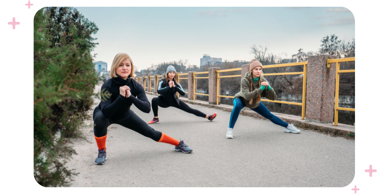A group of women exercising outdoors.