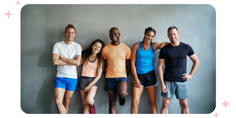 People in workout apparel standing in front of a wall.
