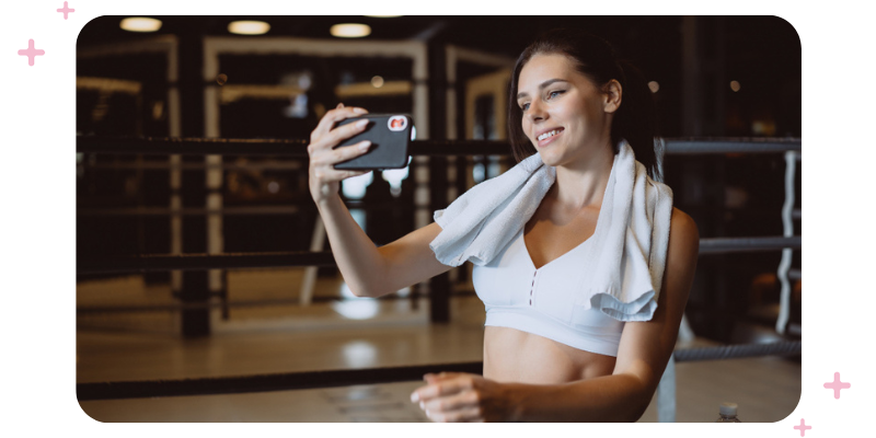 Woman in workout clothes taking a selfie.
