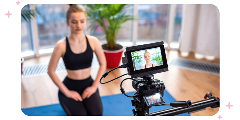 Girl in workout gear recording a video.